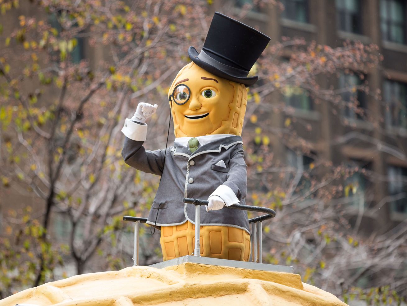 Planters’ Mr. Peanut mascot standing on a Nutmobile float in a parade.