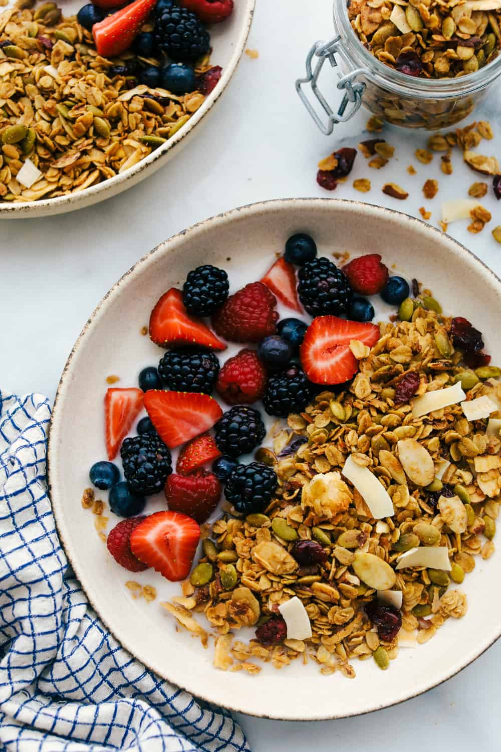 homemade granola in a bowl with fresh fruit and milk. 